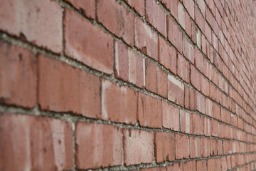 Red brick wall at an angle close up