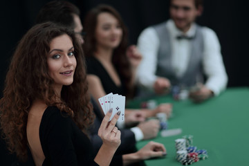 beautiful woman showing a combination of four aces.