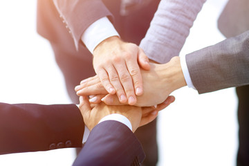 Top view of young people putting hands together