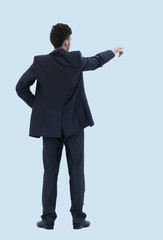 Full length of business man pointing at copyspace