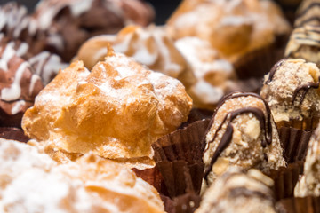 Close-up fresh baked bakery with powdered sugar and white glaze