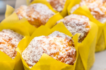 Close-up fresh baked bakery with powdered sugar and white glaze in yellow package