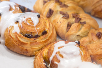 Close-up fresh baked bakery with powdered sugar and white glaze