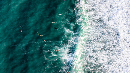 Aerial view of surfers riding a wave in Puerto Rico