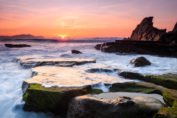 Fototapeta na wymiar amazing sunset landscape at rocky beach