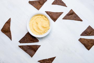 hummus with rye bread on white background