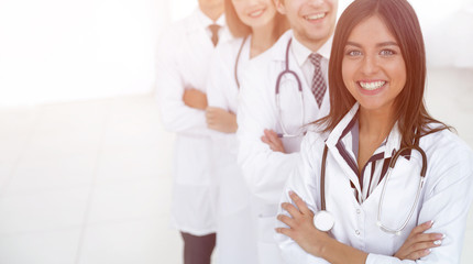 female doctor with group of happy successful colleagues