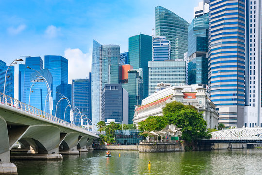 Panoramic View Of Singapore Business Centre From Marina Bay. Skyscrapers And Tropical Plants Under Deep Blue Sky