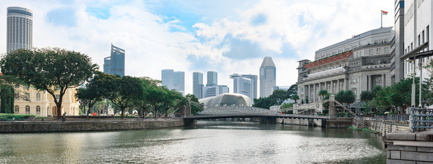 Singapore, panoramic view from river bank to Cavenagh bridge with down-town skyscrapers in background - obrazy, fototapety, plakaty