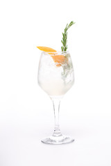 Fototapeta na wymiar champagne cocktail at wineglass decorated with rosemary on white background
