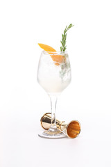 champagne cocktail at wineglass decorated with rosemary on white background
