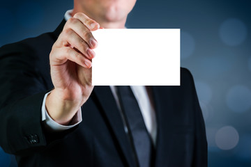 Man holding a white business card with blank for advertising. Copy space