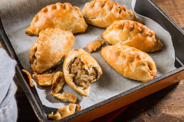 Hot pasties from butter enriched puff pastry filled with minced beef, potato, onions and swede