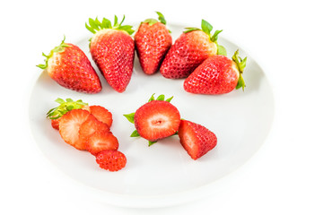 strawberries in white porcelain dish with white background