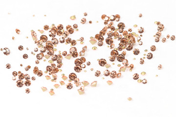 Many scattered rhinestones. On a white background