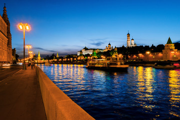 Aerial view of Kremlin at night in Moscow, Russia. Touristic boats