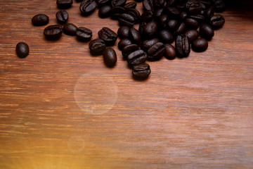 Coffee beans splash on wooden floor.