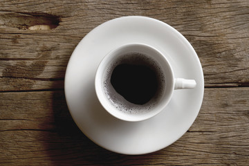White coffee cup on wooden table.