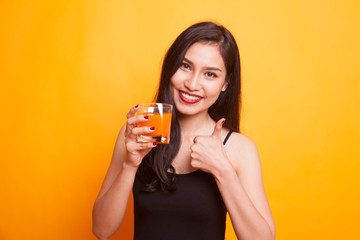 Young Asian woman show victory sign drink orange juice.