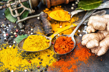 Asian spices dark table background Curry turmeric ginger bay leaf
