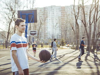man with basketball on the court on a summer day