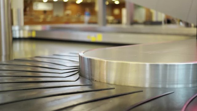 Close up of an empty airport conveyor belt for luggage. Concept of tourism and travel. Locked down real time close up shot