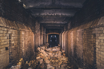 Red brick abandoned underground sewer tunnel with dramatic mysterious atmosphere, inside sewerage - obrazy, fototapety, plakaty