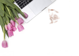 Fototapeta na wymiar Pretty pink tulips on a white tidy desktop