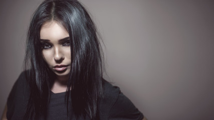 Beautiful girl with make up and dark hair in studio