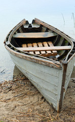 Wooden boat on the beach. Wooden boat on the waterfront.