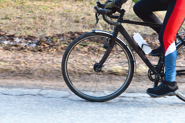 A man travels by Bicycle. Cycling through the forest. To ride a bike.