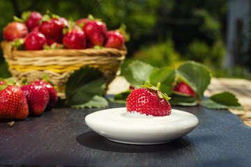 strawberries with cream on stone background, delicious first class organic fruit as a concept of...