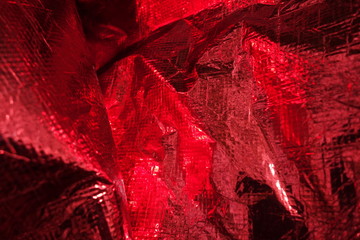 Creased plastic red polyethylene film texture