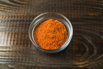 seasoning in a glass jar on a wooden background