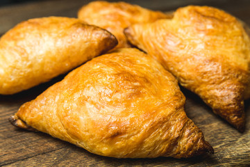Uzbek national dish of samsa on a wooden board