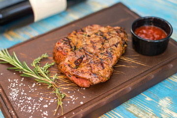 steak with sauce on a wooden board