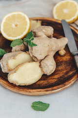 Fresh ginger and lemon on linen tablecloth