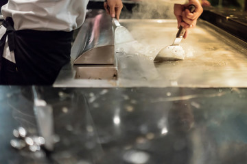 Ice cubes on hot stove. Way to clean and maintenance stainless steel stove after cooking.