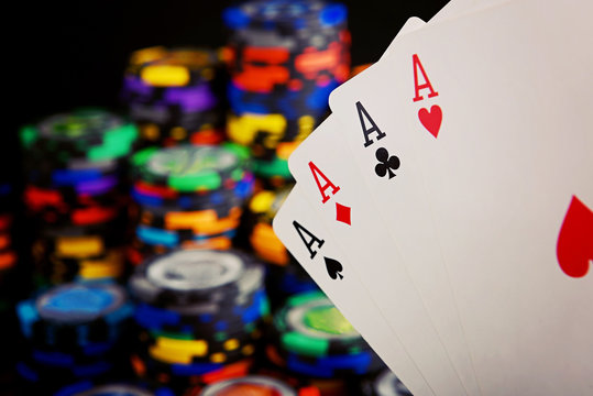 four aces and stack of casino chips