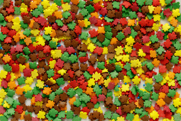Fototapeta na wymiar Sprinkle confectionery multicolored autumn leaves