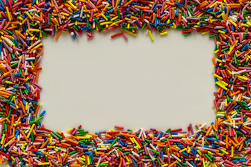The blank for the inscription from the white background and the sprinkling of the confectionery in the form of a multicolored vermicelli