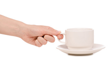 White cup and saucer in hands