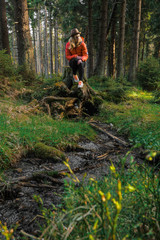 caucasian female hiker standing on a dirt road with big backpack