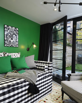 Green Guest Room with Day Bed Couch. Interior in modern black and white. 
