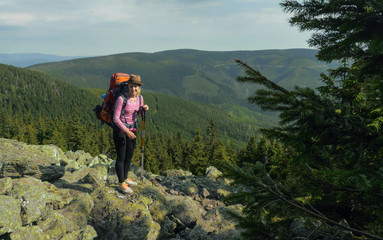 Obraz premium female hiker walking on a trail on highlands, jeseniky mountains, czech republic