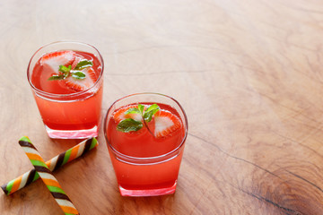 Summer strawberry drink on wooden table.