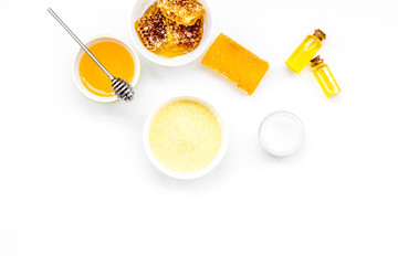 Homemade cosmetics with honey. Handmade soap, spa salt, cream on white background top view