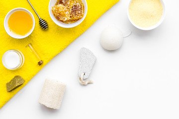 Honey spa set with natural honey, soap, cream, towel and pumice stone on white background top view space for text