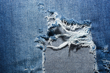 Blue Jean texture with a hole and threads 