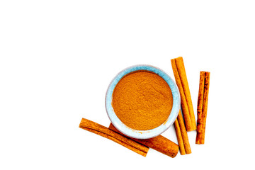 Cinnamon seasoning. Sticks and powder on white background top view copy space